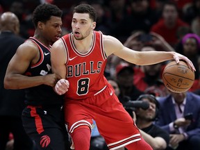 Chicago Bulls guard Zach LaVine, right, drives against Toronto Raptors guard Kyle Lowry Wednesday, Feb. 14, 2018, in Chicago. (AP Photo/Nam Y. Huh)