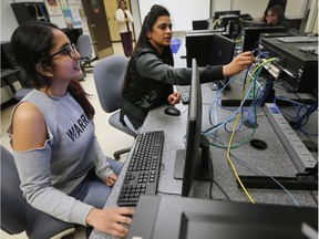 Trushna Patel, left, and Annette Inja, computer networking students at St. Clair College, are shown in a lab class Thursday, Feb. 15, 2018. The college is leading the nation in female computer program students.