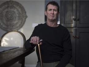 Andrew LaFontaine, who uses a cane after being stung by a bee, is pictured in his LaSalle home on Feb. 6, 2018.   Lafontaine is owed thousands of dollars by another contractor who hired his company to work on LaSalle's new town hall in 2014.
