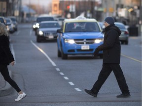 A couple runs across Wyandotte Street East at Chilver Road to beat the traffic on Feb. 27, 2018.