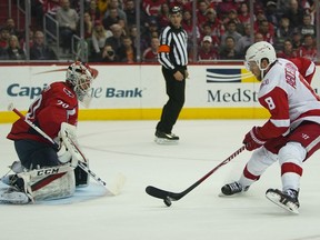 Detroit Red Wings left wing Justin Abdelkader (8) scores on Washington Capitals goaltender Braden Holtby (70) during the first period of an NHL hockey game Sunday, Feb. 11, 2018, in Washington.