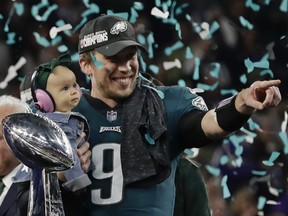 Philadelphia Eagles quarterback Nick Foles (9) holds his daughter, Lily James, after winning the NFL Super Bowl 52 football game against the New England Patriots, Sunday, Feb. 4, 2018, in Minneapolis. The Eagles won 41-33.