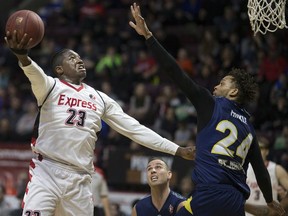 Windsor's Shaquille Keith takes a shot over St. John's Carl English.