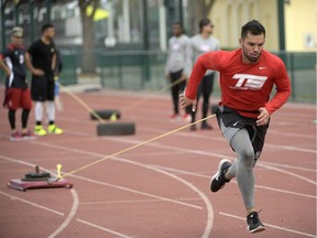 Professional baseball player Vicente Conde uses a football training technique by pulling a sled at the Coach Tom Shaw Performance camp Monday, Jan. 22, 2018, in Lake Buena Vista, Fla. Weight sleds and tires await the boys of summer for the kind of workouts typically reserved for men who make their living on the gridiron in the fall.