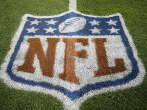 FILE - In this Nov. 12, 2017, file photo, an NFL logo is displayed on the field before an NFL football game between the New England Patriots and the Denver Broncos in Denver.