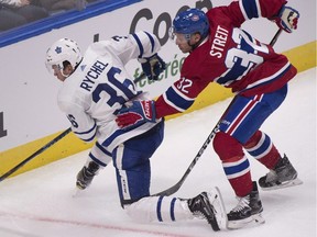 In exhibition play in September, Montreal Canadiens' Mark Streit, right, pushes Toronto Maple Leafs' Kerby Rychel during the second period of exhibition. Rychel is now a member of the Montreal Canadiens.
