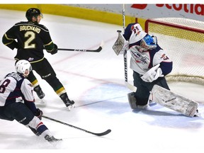 London Knights defenceman Evan Bouchard can't redirect a backhand by teammate Nathan Dunkley, which is handled by Windsor Spitfires goalie Mickey DiPietro  during Monday's game at Budweiser Gardens in London. Mike Hensen/The London Free Press/Postmedia Network