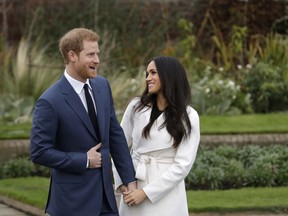 FILE - In this file photo dated Monday Nov. 27, 2017, Britain's Prince Harry and his fiancee Meghan Markle pose for photographers in the grounds of Kensington Palace in London, following the announcement of their engagement. Speculation is mounting over who will be invited to the May 19, 2018, royal wedding of Prince Harry and Meghan Markle, with pundits guessing about the wedding guest list.