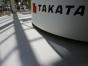 In this May 4, 2016, photo, shadows are cast near a Takata Corp.'s reception desk at the automaker's showroom in Tokyo.