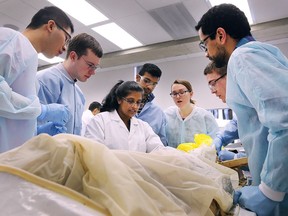Anatomist Anna Farias, centre in white, instructs second year medical students during a gross anatomy lab class at the Schulich School of Medicine & Dentistry at the University of Windsor on Feb. 7, 2018.