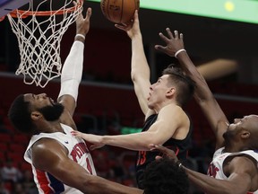 Detroit Pistons center Andre Drummond, left, prepares to swat the ball away from Portland Trail Blazers center Zach Collins (33) during the first half of an NBA basketball game, Monday, Feb. 5, 2018, in Detroit.