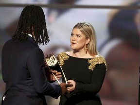 In this photo provided by the NFL, Todd Gurley of the Los Angeles Rams, left, accepts the award from Kelly Clarkson for The Associated Press 2017 NFL Offensive Player of the Year at the 7th Annual NFL Honors at the Cyrus Northrop Memorial Auditorium on Saturday, Feb. 3, 2018, in Minneapolis.