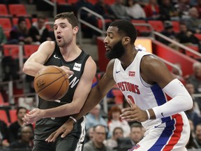 Brooklyn Nets guard Joe Harris passes the ball as Detroit Pistons center Andre Drummond closes in during the first half of an NBA basketball game on Feb. 7, 2018, in Detroit.