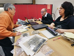 The Northstar Cultural Community Centre hosted a community open house to celebrate local black history on Saturday, February 3, 2018 at the Windsor Public Library main branch. Melinda Wilson, left, brought several old photos from her family history that were being digitally copied at the event. Jim Allen and Rebecca Canty from the organization where handling the photos that will be part of an online archive.