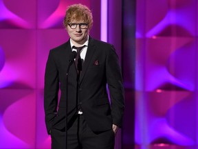 FILE - In this Nov. 30, 2017, file photo, Ed Sheeran presents the award for executive of the year at the Billboard Women in Music event at the Ray Dolby Ballroom in Los Angeles.