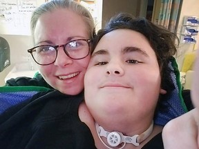 Betty-Joe MacDonald and her son Phoenix MacDonald-Gagnon, 14, who woke suddenly on the night of Sept. 27 unable to move any part of his body from the neck down.