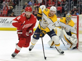 Detroit Red Wings left wing Justin Abdelkader (8) is guarded by Nashville Predators defenseman Mattias Ekholm (14) in the second period of an NHL hockey game, Tuesday, Feb. 20, 2018, in Detroit.