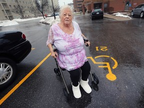 Rose Black, 78, sits in her walker in the handicap parking spot where her car was recently stolen twice. She is shown on Thursday, Feb. 15, 2018 at her Windsor apartment building.