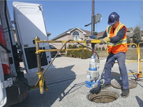 Serge Cossette, a sewer inspector with Aqua Data, uses a camera to inspect a municipal sewer on Windsor's Geraldine Crescent, Feb. 28, 2018.