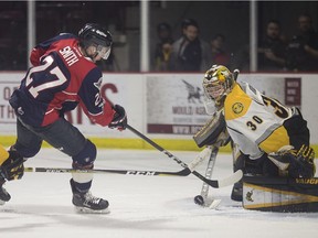 Windsor Spitfires forward Jake Smith has his shot turned away by Sarnia Sting goalie Aldan Hughes during Thursday's game at the WFCU Centre