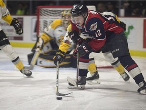 WINDSOR, ONT:. FEB.1, 2018 -- Windsor's William Sirman battles Sarnia's Franco Spoviero for the puck during OHL action between the Windsor Spitfires and the Sarnia Sting at the WFCU Centre, Thursday, February 31, 2018.
