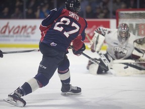 Windsor's Jake Smith scores against  Guelph's goalie Anthony Popovich earlier this season.