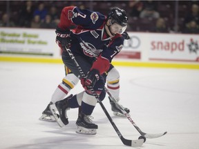 Windsor's Tyler Angle races for the puck against Barrie's Justin Murray during OHL action between the Windsor Spitfires and the Barrie Colts at the WFCU Centre, Thursday, Feb. 15, 2018.