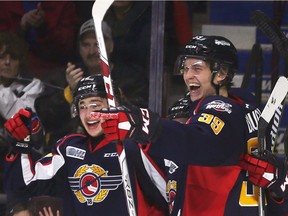 Windsor Spitfires defenceman Thomas Stevenson, left, and teammate Curtis Douglas celebrate one of six first-period goals during Sunday's game against the Flint Firebirds at the WFCU Centre.