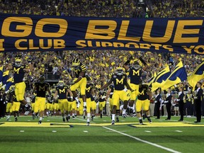 The University of Michigan football team takes the field prior to their 35-31 win over Notre Dame on Saturday night in Ann Arbor, Michigan.