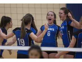 Sandwich's Anna Scarfe, centre, and Lilly Hearn, centre-right, celebrate with teammates on Thursday after a point en route to the team's SWOSSAA girls' AA volleyball title, which completed a perfect season.