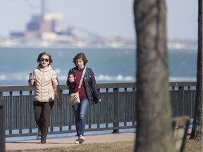 Maha Mirza, left, and Nagham Gabriel, take a stroll along the waterfront on an unseasonably warm day, Monday, February 26, 2018.