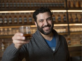 Adriano Ciotoli, owner of WindsorEats, holds up a glass of whisky at the J.P. Wiser's tasting room, Tuesday, February 20, 2018.