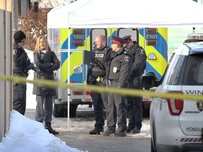 Windsor police officers confer in the 900 block of Church Street where the body of 16-year-old Chance Gauthier was found on the morning of Feb. 14, 2018. Gauthier died from a gunshot wound.