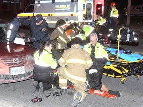 Essex-Windsor EMS paramedics, Windsor firefighters and Windsor police attend to two pedestrians who were struck on Ouellette Avenue south of Shepherd Street shortly before 10 p.m. on March 16, 2018.