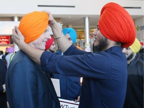 University of Windsor President Alan Wildeman is fitted for a turban by Dilpreet Singh right, during Sikh Awareness and Turban Day at the school March 19, 2018.  Sikh Awareness Day is held by the Sikh Students Association at University of Windsor and Windsor Gurdwara.