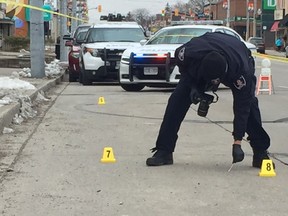 A Windsor police officer collects evidence following an early morning assault on March 9, 2018. Access to several businesses in the 5900 block of Wyandotte Street East was blocked while police investigated.