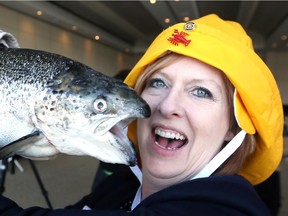 Rotary Club of Windsor-Roseland member Andrea Baillargeon simulates kissing a cod during a kickoff event for 34th Annual Lobsterfest - A Maritime Party, A Screech of a Good Time at St. Clair College Centre for the Arts March 20, 2018.  The actual Lobsterfest is May 25 at St. Clair College Centre for the Arts.