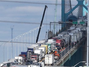 Bumper-to-bumper trucks enter Canada from Detroit via the Ambassador Bridge on March 23, 2018.