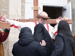 Nick Simone plays the part of Jesus during a re-enactment of Christ's crucifixion in Amherstburg, March 30, 2018. For the past 40 years, St. John the Baptist Catholic Parish holds a special Good Friday service and procession through the town's streets. Amherstburg police conducted moving detours as hundreds, many praying, follow Jesus and two thieves as they are led to their deaths.