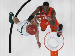 Miles Bridges of the Michigan State Spartans dunks the ball against the Syracuse Orange in the second round of the 2018 NCAA Men's Basketball Tournament at Little Caesars Arena on March 18, 2018 in Detroit, Michigan.