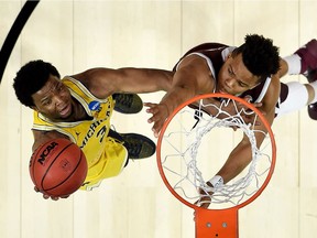 Zavier Simpson of the Michigan Wolverines goes up for a shot against the Texas A&M Aggies in the 2018 NCAA Men's Basketball Tournament West Regional at Staples Center on March 22, 2018 in Los Angeles, California.