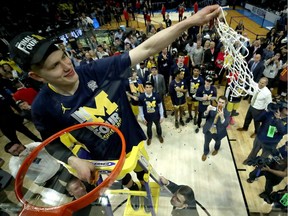 Moritz Wagner of the Michigan Wolverines cuts down the net after the Wolverines 58-54 victory against the Florida State Seminoles in the 2018 NCAA Men's Basketball Tournament West Regional Final at Staples Center on March 24, 2018 in Los Angeles, California.