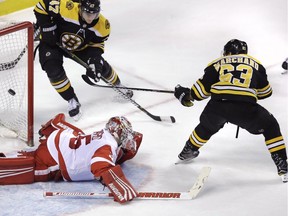 Boston Bruins left wing Brad Marchand (63) flicks a backhand shot over Detroit Red Wings goaltender Jimmy Howard (35) for the game-winning goal during the overtime period of an NHL hockey game in Boston, Tuesday, March 6, 2018. Marchand notched a hat trick in the Bruins' 6-5 win.