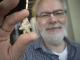 Jim Molnar, from Fisher Archaeological Consulting, holds a projectile point from about 7500 B.C., discovered during construction of the Sandwich roundabout. Various found objects were displayed at the Chimczuk Museum Thursday, March 8, 2018.