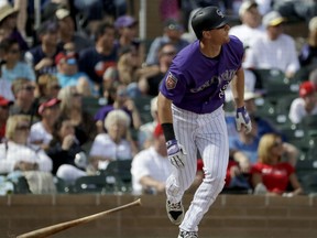 Colorado Rockies' DJ LeMahieu watches his grand slam against the Los Angeles Angels during the fourth inning of a spring baseball game in Scottsdale, Ariz., Thursday, March 15, 2018.
