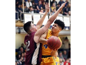 Aaron Bossio, left, of St. Mary's tries to block Dennard Simonato, of the Kennedy Clippers, during their OFSAA boys' AAA basketball game on Monday.