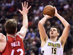 Denver Nuggets centre Nikola Jokic (15) shoots over Toronto Raptors centre Jakob Poeltl (42) during second half NBA basketball action in Toronto on Tuesday, March 27, 2018.