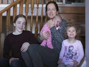 Town of Essex Coun. Sherry  Bondy, with her children, Katrina, 13, left, Kara, 2, and Gwen, 3 weeks, at her home in Harrow, Saturday, March 24, 2018. She argues that providing user-pay daycare at municipal conferences will help younger people with families participate in municipal politics.