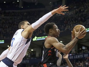 Toronto Raptors guard DeMar DeRozan (10) shoots past Dallas Mavericks centre Dwight Powell (7) during first half NBA basketball action in Toronto on Friday March 16, 2018.