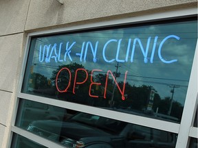 The neon sign in the window of a Windsor walk-in clinic is shown in this file photo from 2016.
